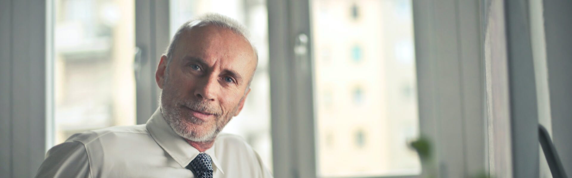 Business Valuation banner showing a man wearing a shirt and tie.