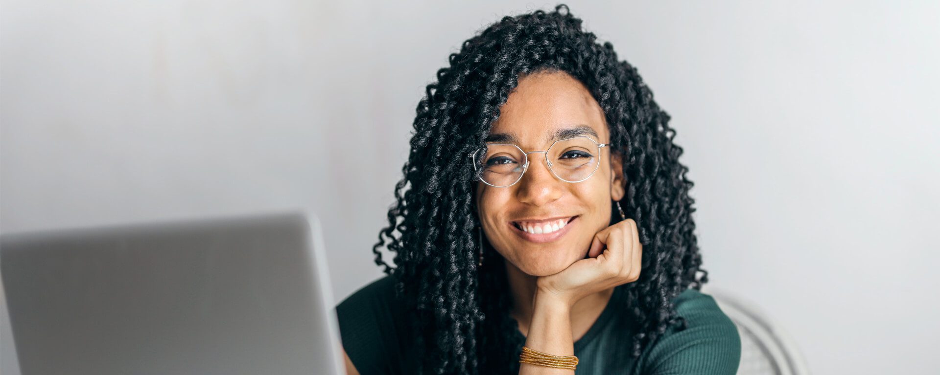 Corporate tax banner image showing a woman by a laptop
