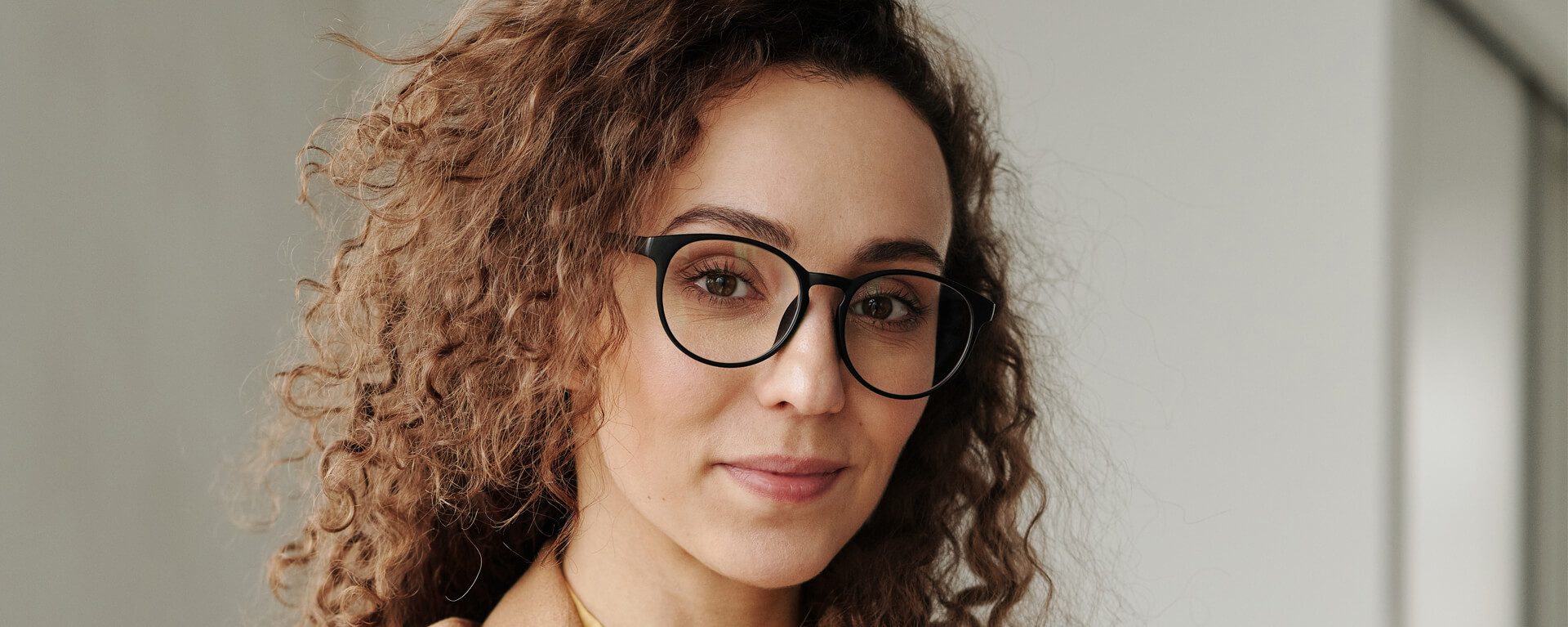 Global Mobility Services banner showing a woman with glasses and curly hair