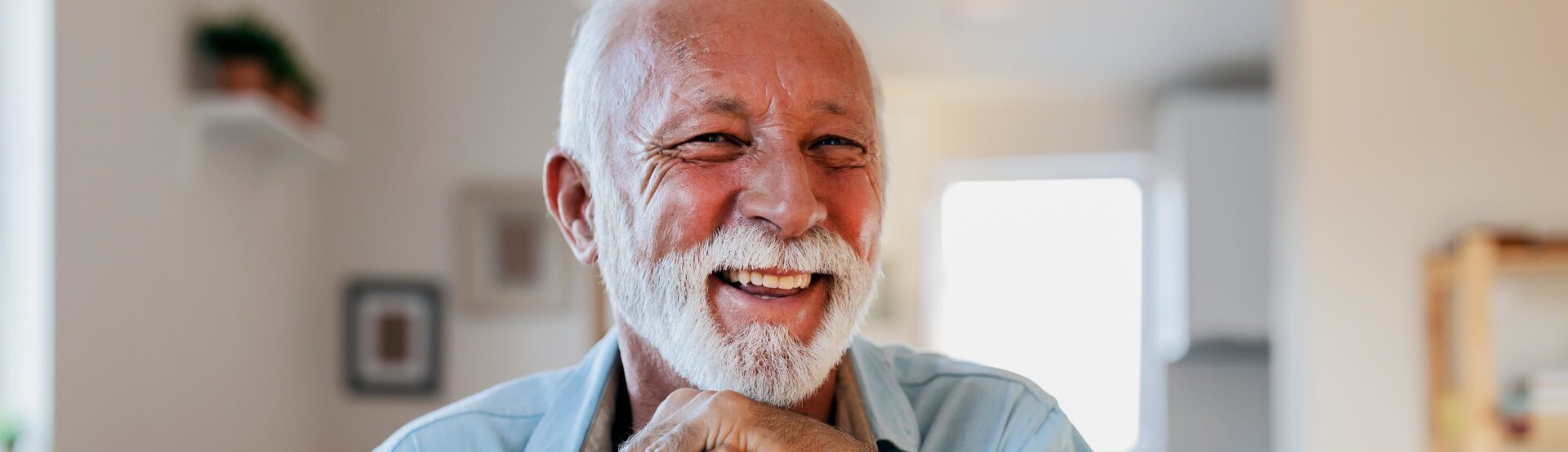 A person with a white beard smiling and laughing - property tax accountant services