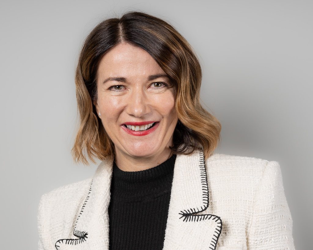 Gillian Forrest AAB wearing a white blazer with a black top.