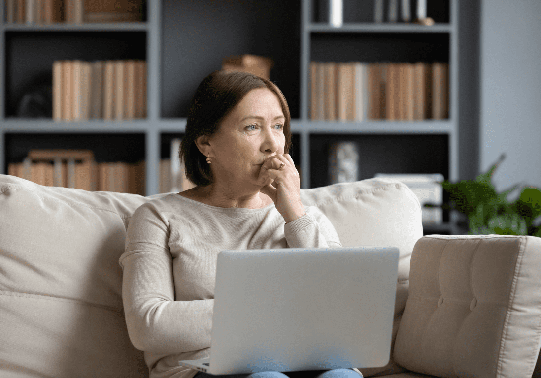 Woman sitting looking pensive on a couch