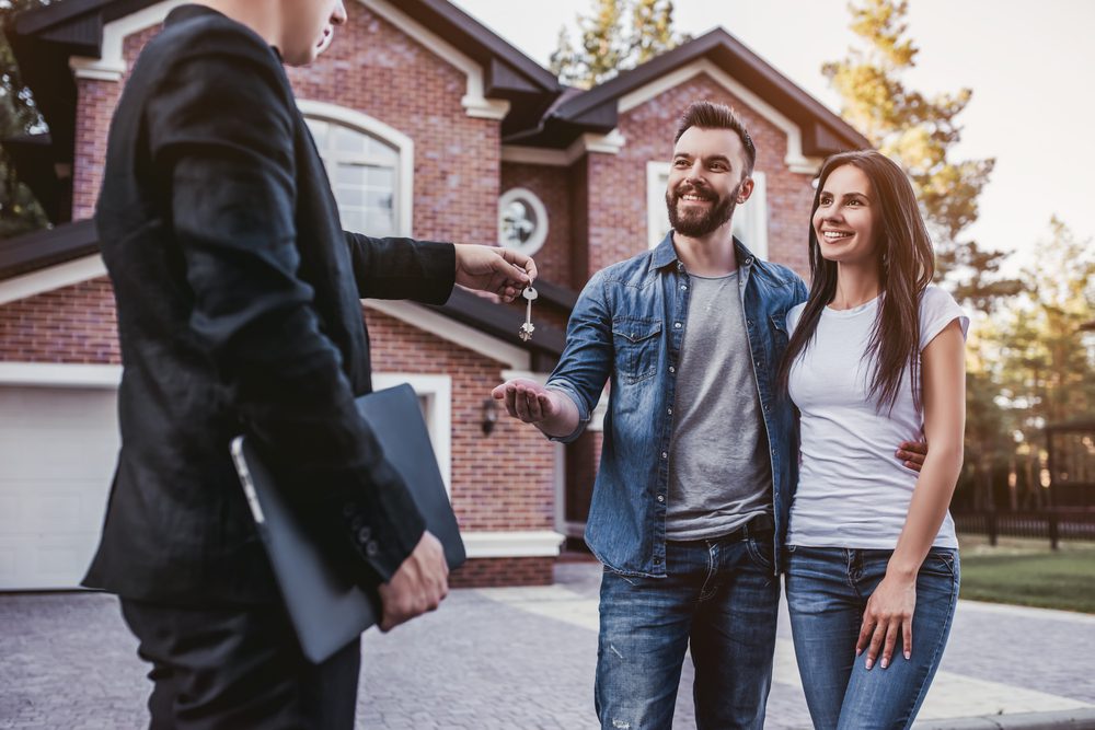 Image of couple getting the keys for their property they paid inheritance tax on