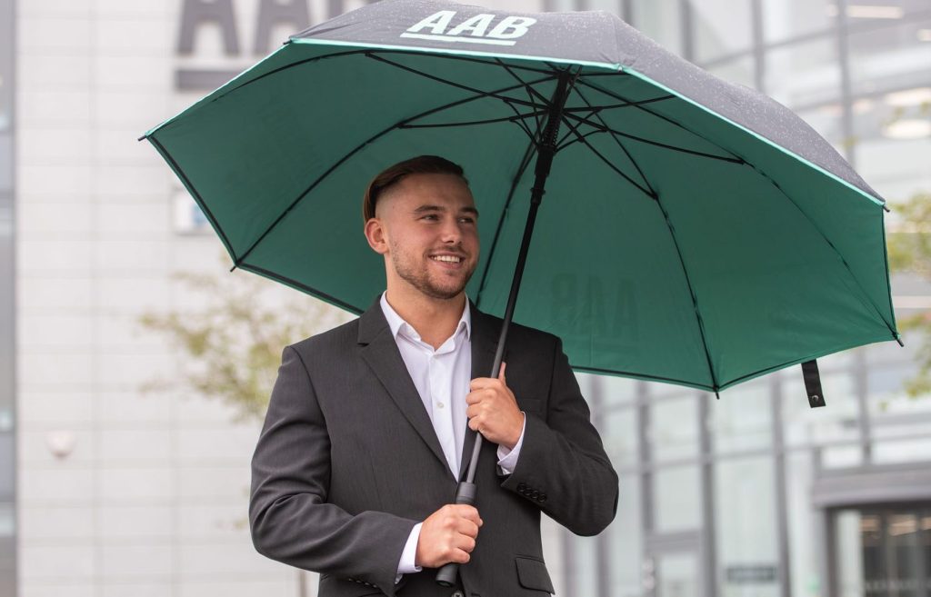 AAB Team member with umbrella.