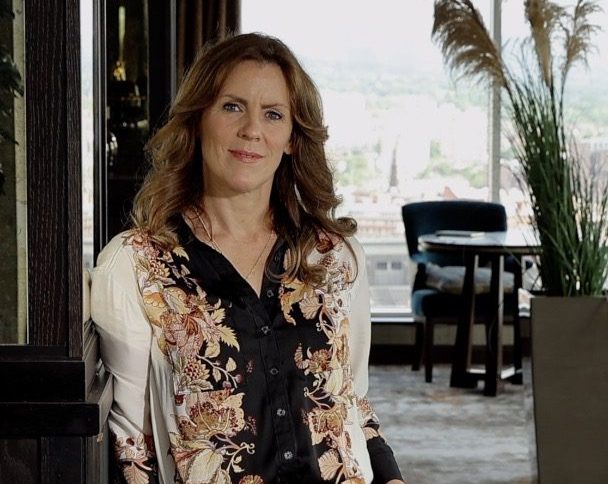 Emer Hinphey, Partner at AAB People, wearing flowery blouse.
