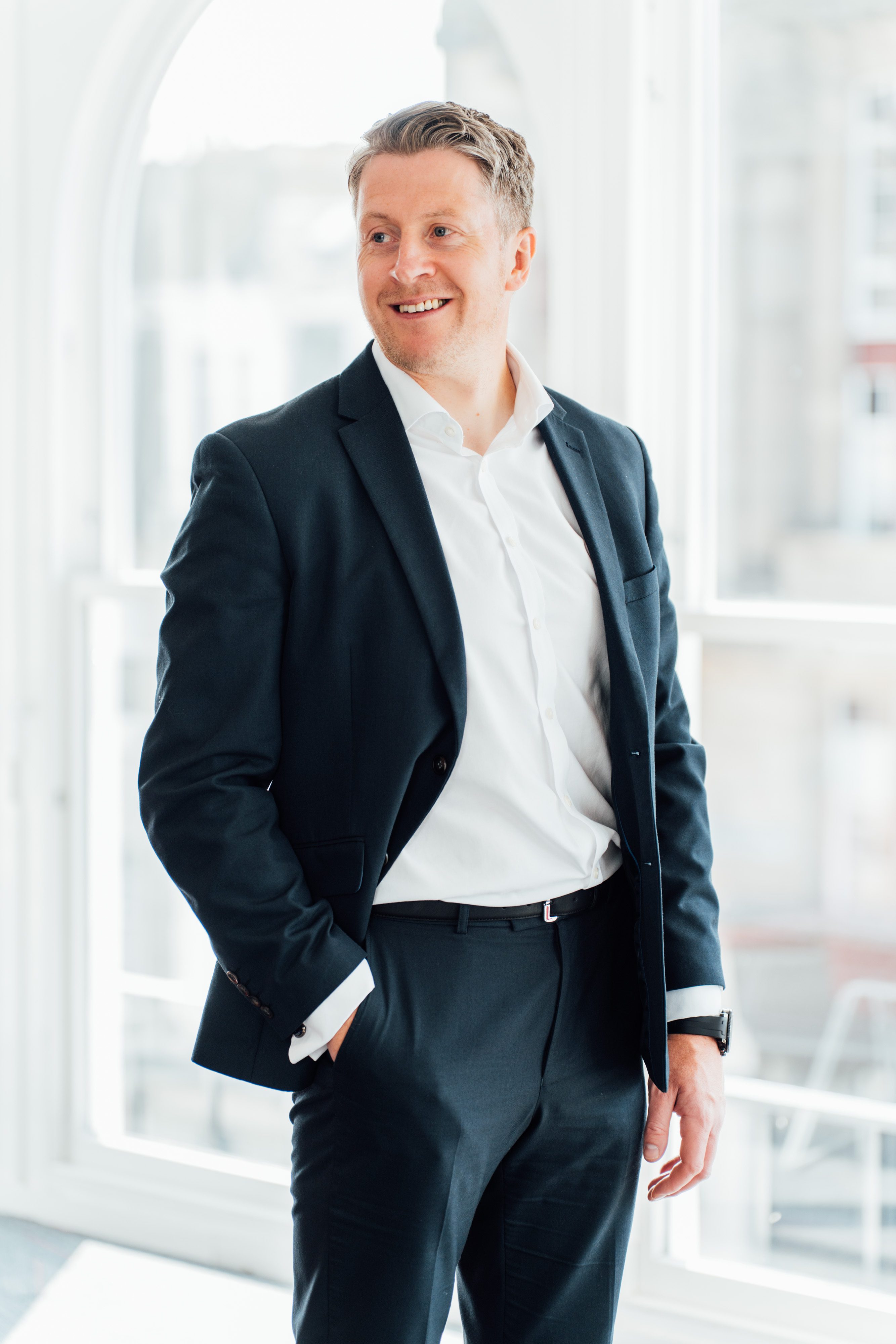 An image of Paul Turner standing in the Edinburgh office and smiling at the camera.